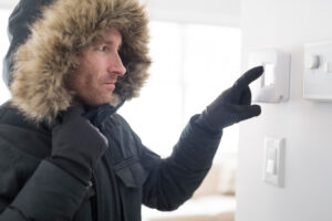 A Man With Warm Clothing Feeling The Cold Inside House